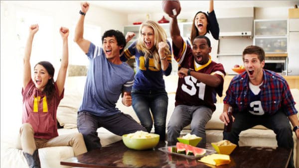 Friends celebrating with food at a super bowl party