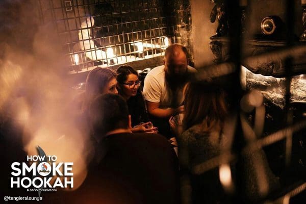 Group smoking hookah at a hookah lounge.