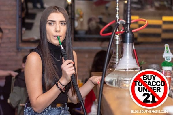 Young woman smoking hookah at a hookah bar