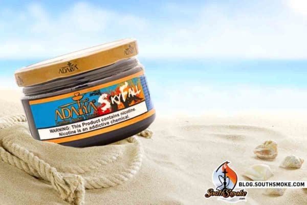 adalya skyfall shisha jar on beachy sand with decorative rope and seashells