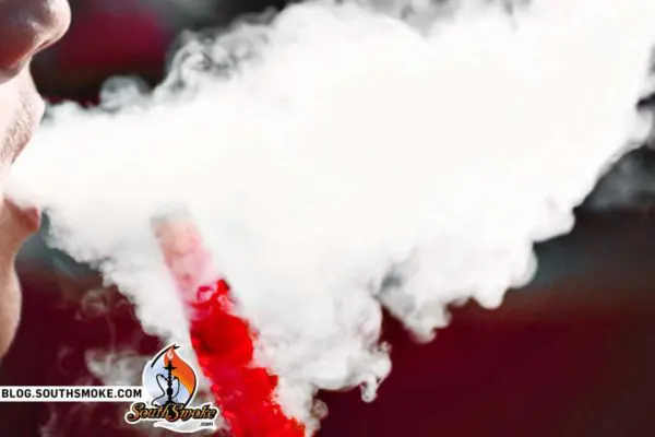 Close up of someone blowing hookah smoke