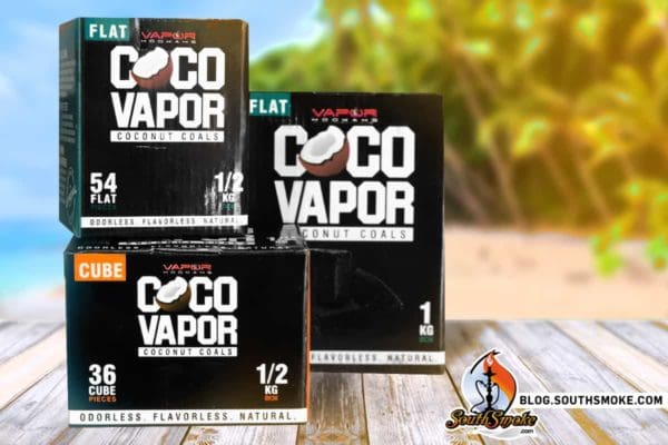 Vapor Hookah USA CocoVapor Coconut Coals on a wooden table with a beach scene in the background.